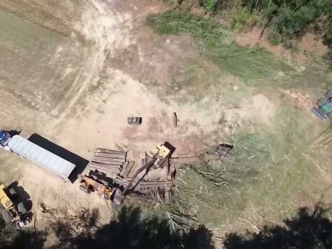 Aerial view of a landing with loaders and a chip trailer